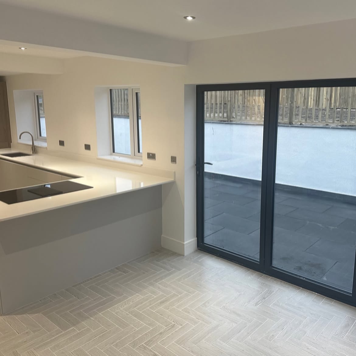 Completed kitchen with herringbone flooring and anthracite doors